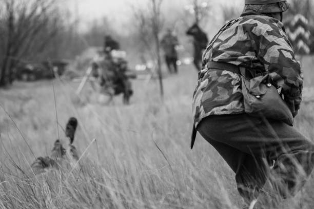 istock German soldier attacks the enemy in the high grass 1095412066