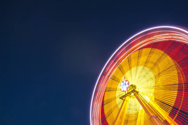 istock Ferris wheel at slow shutter speeds with gorgeous lights 1095412542