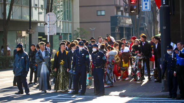 les nouveaux adultes japonais portant des kimonos sur la «venue du jour d'âge» dans la rue à yokohama - obi sash photos et images de collection