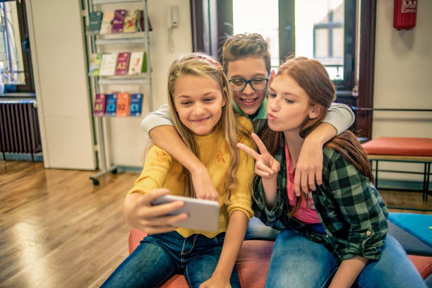 istock group of friends at school taking a selfie 1095420222