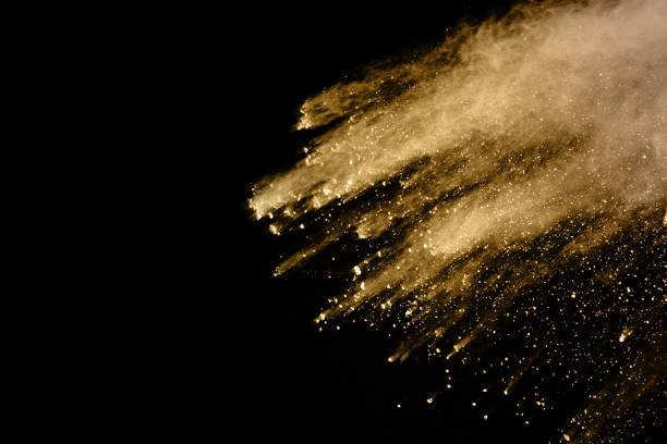 istock Golden powder explosion on black background. Freeze motion. 1095421796