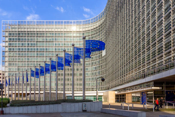 EU Flags in front of the European Union building Brussels, Belgium - July 30, 2014: Row of EU Flags in front of the European Union Commission building in Brussels. capital region stock pictures, royalty-free photos & images