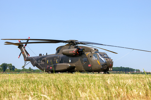Norvenich, Germany - June 12, 2015: German army Sikorsky CH-53 Stallion transport helicopter in the grass at Norvenich airbase.