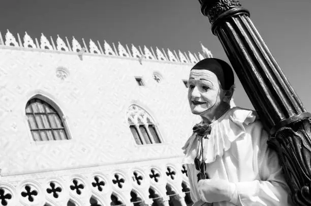 Black and White Photo of Pierrot with Red Rose Posing in San Marco Square