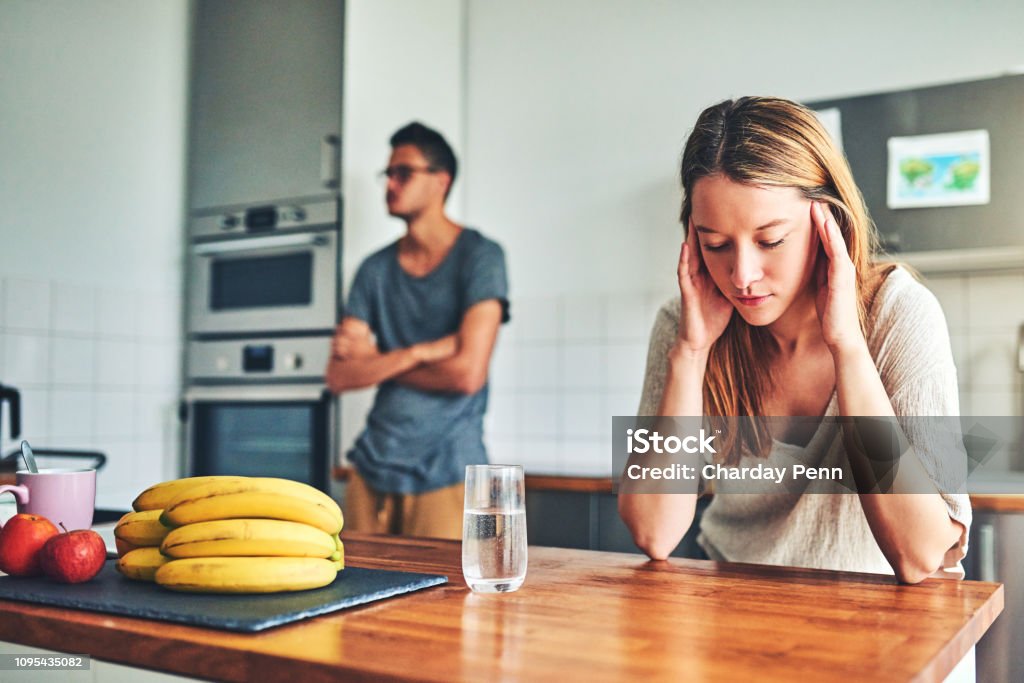 I just want the fighting to stop Shot of a couple having a disagreement at home Divorce Stock Photo