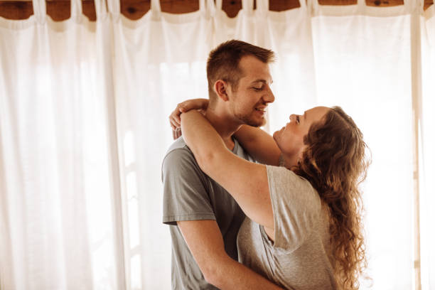 istock eambracing couple at home 1095438950