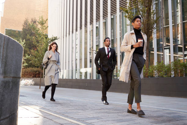 istock Three millennial city workers walking in the street, low angle, full length 1095439938