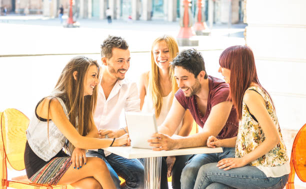 istock Friend group sitting at restaurant bar having fun with tablet pc - Connected community of young students people using portable computer - Millennial generation concept sharing content on social media 1095442014
