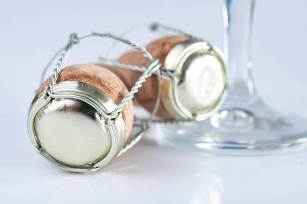 Champagne cork and metal basket on the table. Special closure from sparkling wine. Light background.