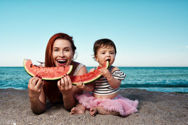 istock enjoy delicious watermelon on the beach 1095454618