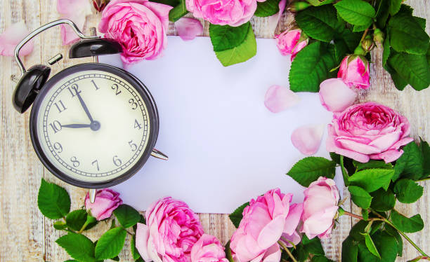 istock Alarm clock 10 hours. Flowers. Selective focus. 1095457956