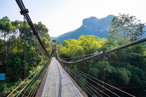 istock iron suspension bridge for cross the river 1095459722