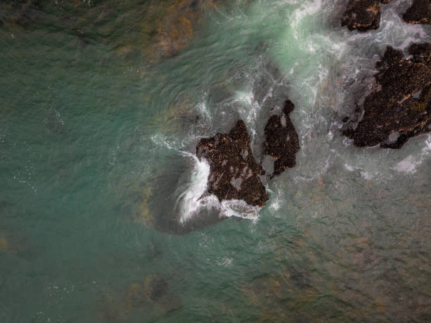 istock Tide crashing on coastal rocks 1095461366