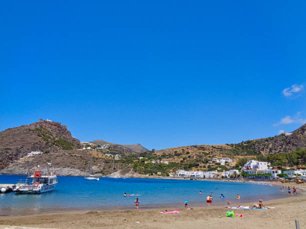 istock beach with people and boat 1095469174