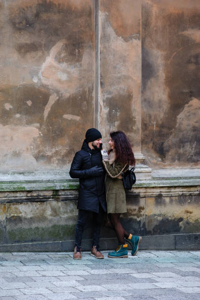 istock Young romantic couple is having fun outdoors in winter before Christmas. Enjoying spending time together in New Year Eve. Two lovers are hugging and kissing in Saint Valentine's Day. 1095469980
