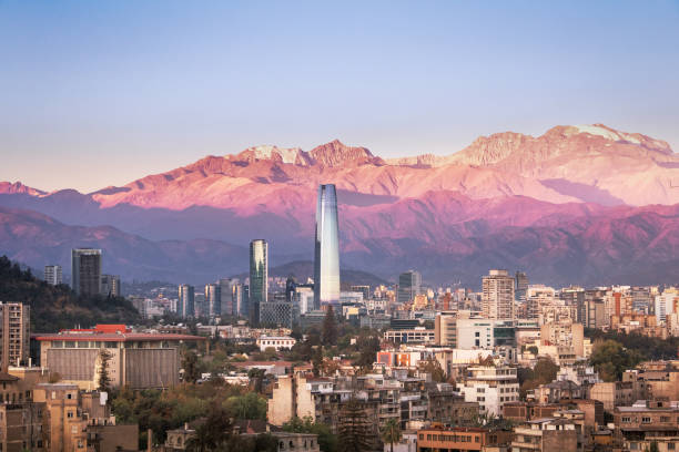 Aaerial view of Santiago skyline at sunset with Costanera skyscraper and Andes Mountains - Santiago, Chile Aaerial view of Santiago skyline at sunset with Costanera skyscraper and Andes Mountains - Santiago, Chile santiago chile photos stock pictures, royalty-free photos & images