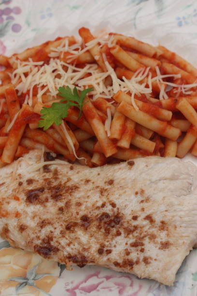 istock Turkey breast served with macaroni in tomato sauce 1095478896