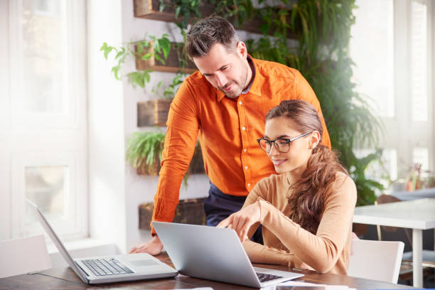 istock Group of business people using laptops while working together in the office 1095482950