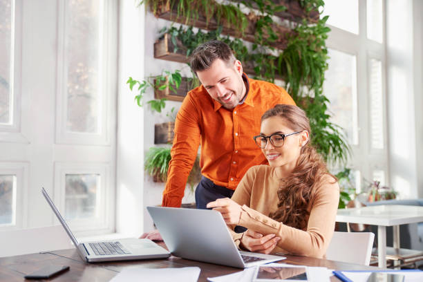 istock Group of business people using laptops while working together in the office 1095483188