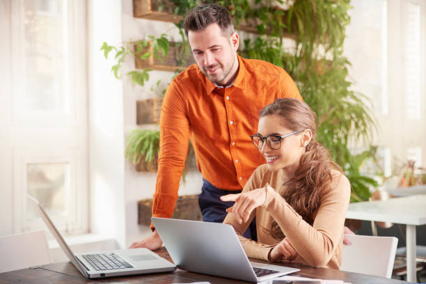 istock Group of business people using laptops while working together in the office 1095483216
