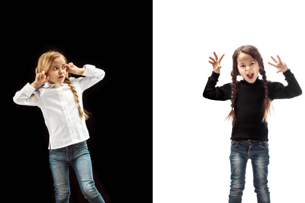 istock Angry teen girls standing on studio background. 1095498178