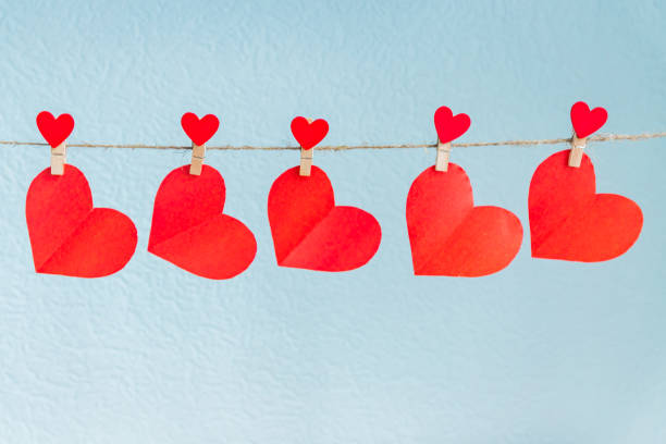 istock Love hearts hanging on rope on a blue background 1095503170