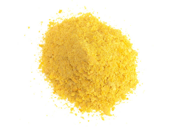 flakes of yellow nutritional yeast a cheese substitute and seasoning for vegan cooking - yeast imagens e fotografias de stock