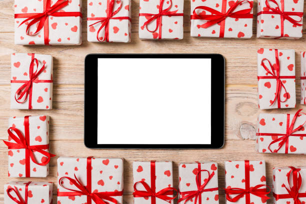 istock Beautiful celebratory valentine day or other holidays background. tablet with blank screen on the wooden background. Digital technology. top view Tablet copy space 1095513232