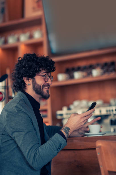 istock Man sitting in the coffee shop and using phone 1095517974