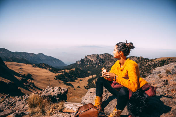 Lunch time. Tired Latin woman making a launch break. She is hiking at Popocatepetl volcano in Mexico popocatepetl volcano photos stock pictures, royalty-free photos & images