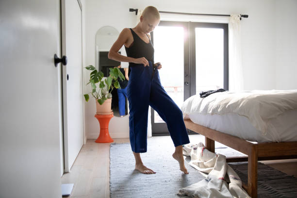 Woman gets dressed in the morning before work