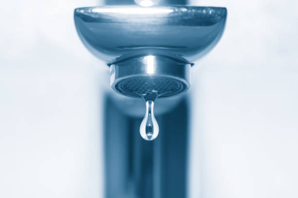 istock Water tap and falling drop close up 1095521698