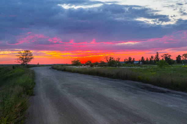 istock dirt road in the field on a summer evening 1095522570