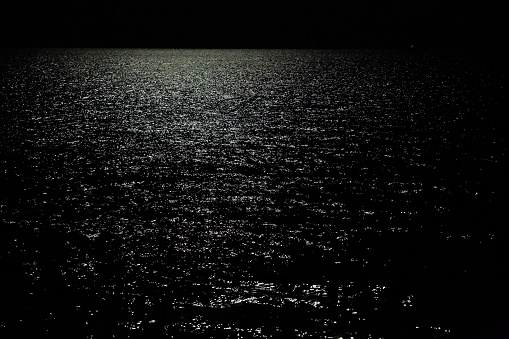 glare of moonlight on the surface of the sea at night