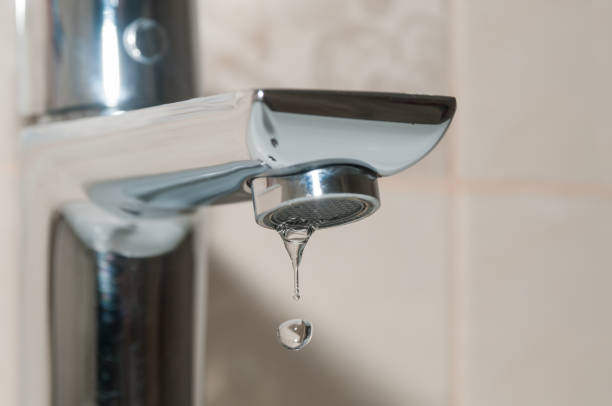 istock Bath faucet and water drops close up 1095526112