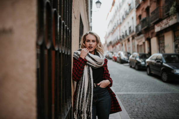 istock Young woman putting on a scarf 1095529016