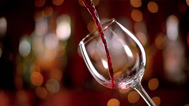 istock Freeze motion of pouring red wine into goblet 1095533192