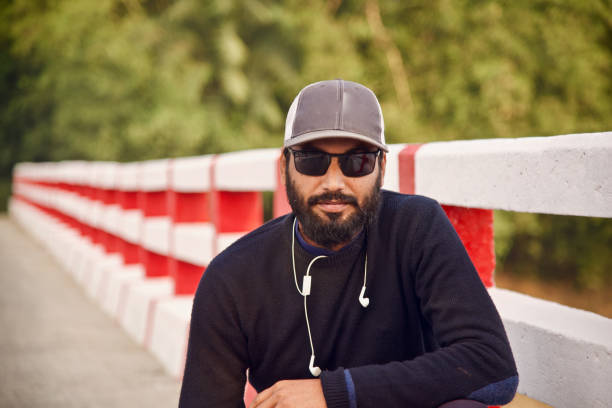istock Man wearing a cap sitting in a place unique photo 1095534214