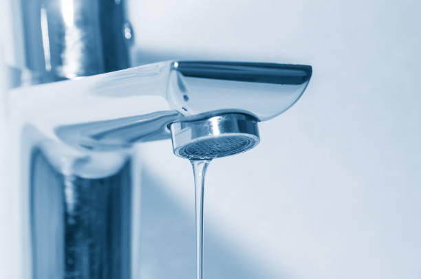 istock Faucet with flowing water close up 1095534568