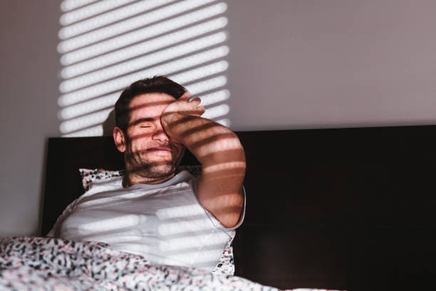 istock Young man waking up in the bed in the morning 1095536500