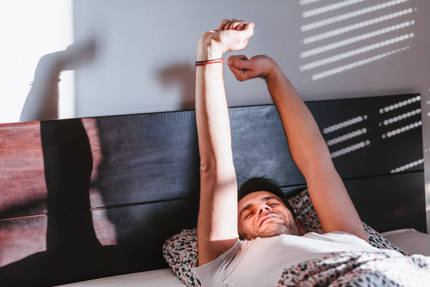 istock Young man waking up in the bed in the morning 1095536506