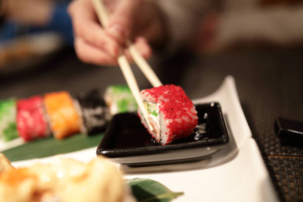 istock Person takes Uramaki Sushi 1095537068