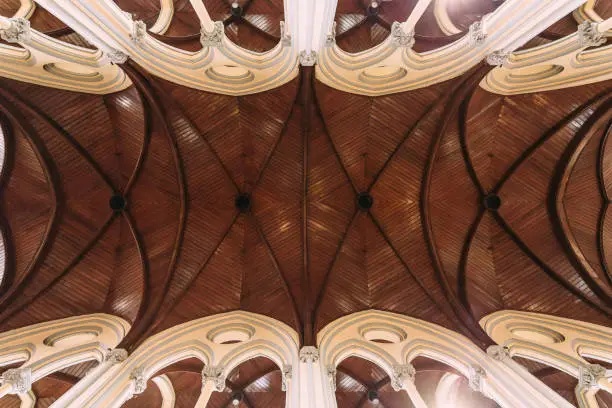 Photo of Cathedral of Saint Mary of the Assumption wooden arch ceiling with sunlight.