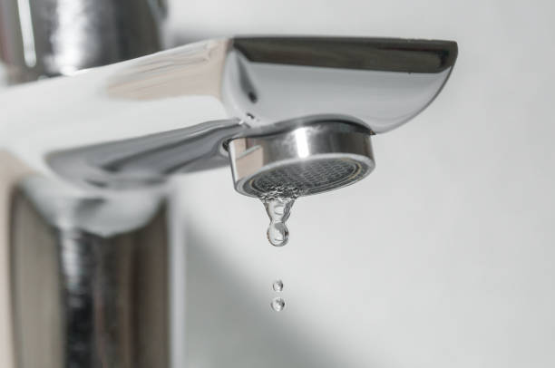 istock Bath faucet with water drops close up 1095537284