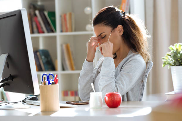 istock Tired young business woman having headache while working with computer in the office. 1095537726