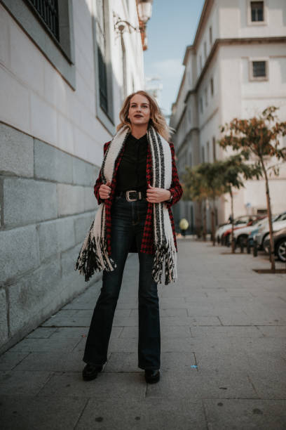istock Young woman putting on a scarf 1095541162