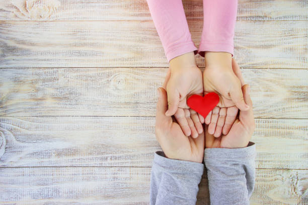 istock child and father have a heart in their hands. Selective focus. 1095542338