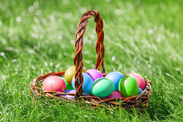 istock Closeup of colorful Easter eggs in a basket on a lawn 1095542870