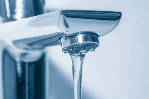 istock Metal tap with flowing water close up 1095545480