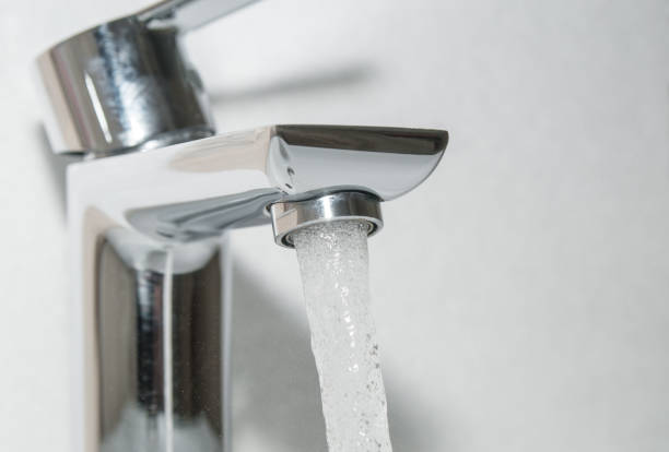 istock Flowing water from bath faucet close up 1095547424